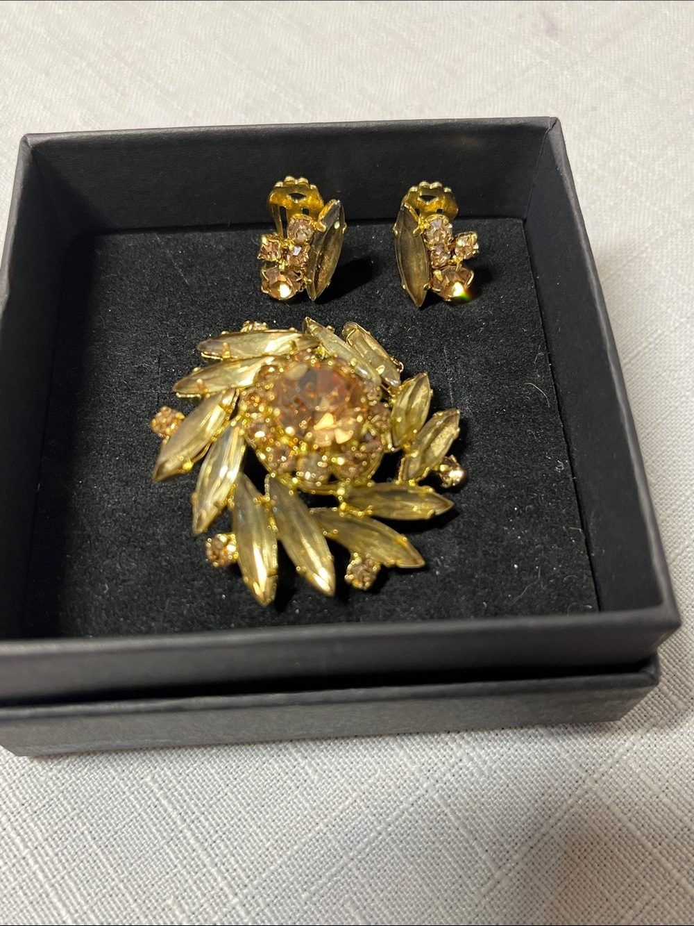 Vintage Austrian crystal brooch and clip on earrings. Gold tone. Unique. Stamped